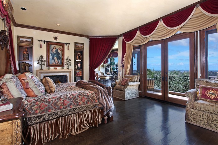 Luxurious Bedroom with Fireplace and Balcony View