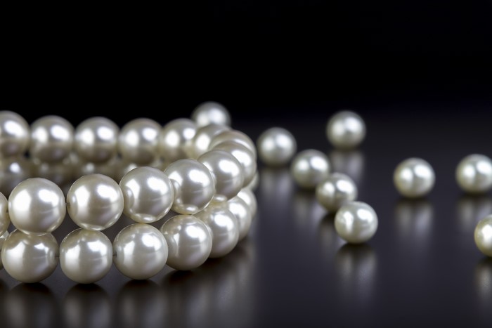 Pearl necklace on a dark background