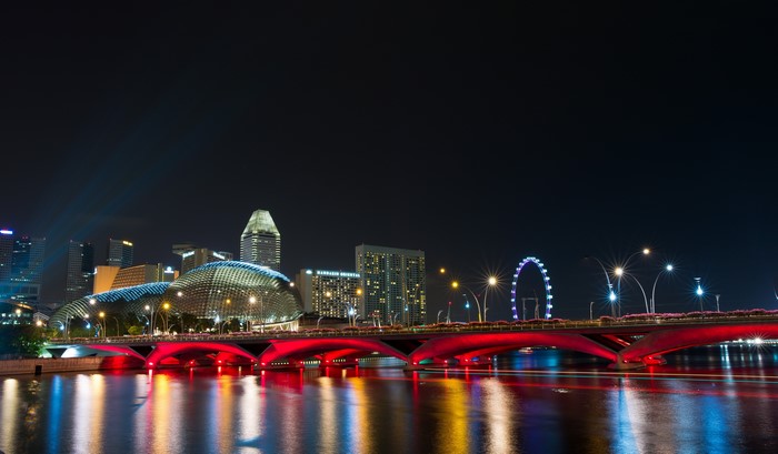 Singapore skyline with illuminated bridge at night