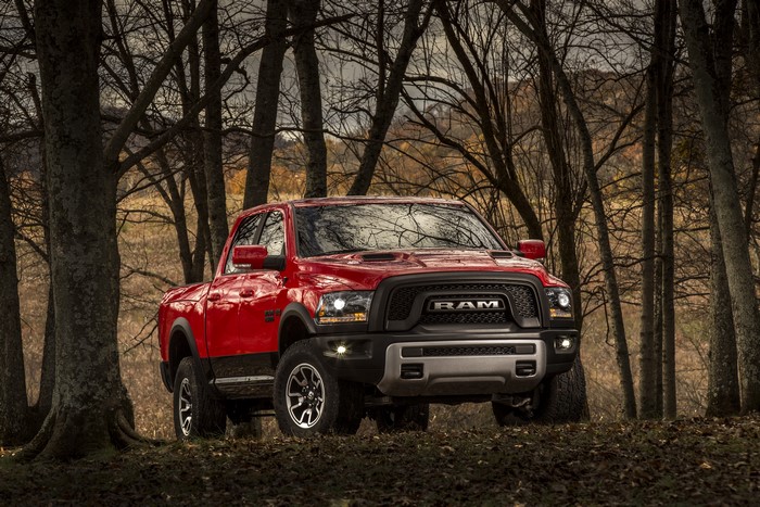 Red 2015 Ram 1500 Rebel truck in forest