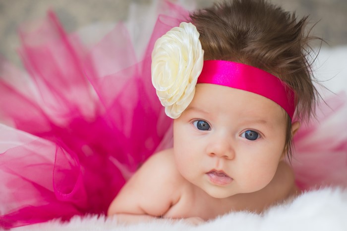 Baby girl with flower headband and pink tutu