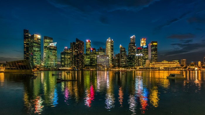 Singapore skyline with skyscrapers and river at night