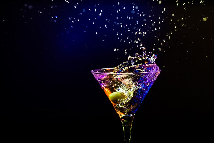 Cocktail with water splash in martini glass