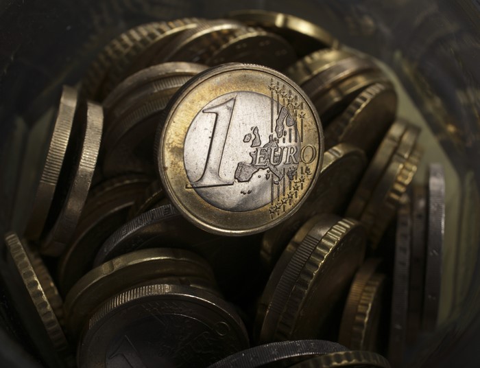 One Euro Coin and Stack of Coins
