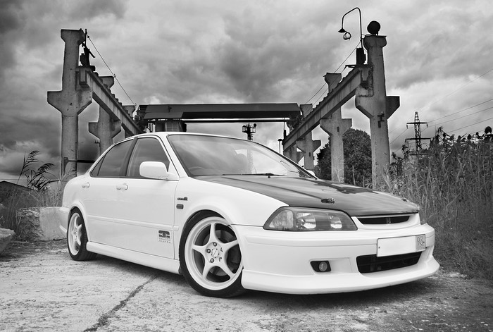 White Honda Accord with black hood and industrial background
