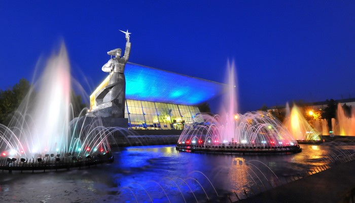 Monument and illuminated fountains at night