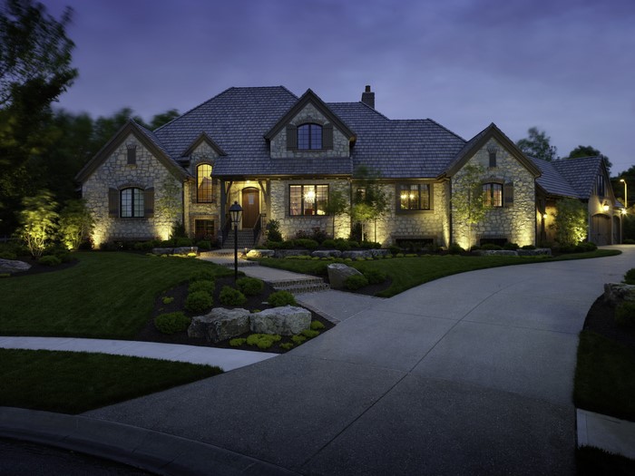 Stone Mansion with Exterior Lighting at Night