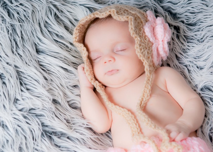 Baby sleeping in a knitted hat