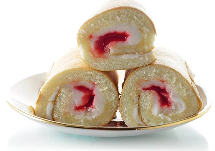 Three Swiss Rolls with Strawberry Filling on a Plate