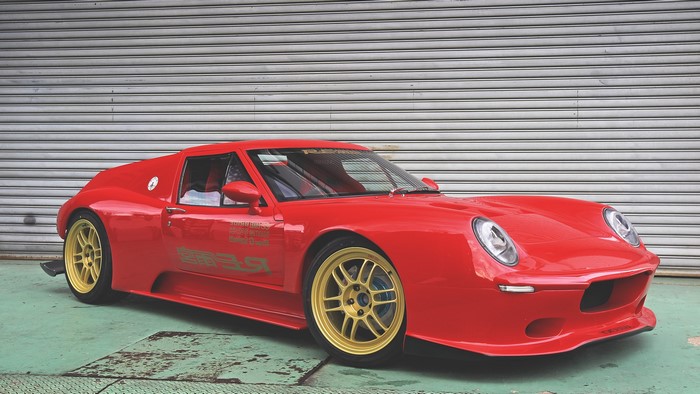 Red Lotus sports car with gold rims