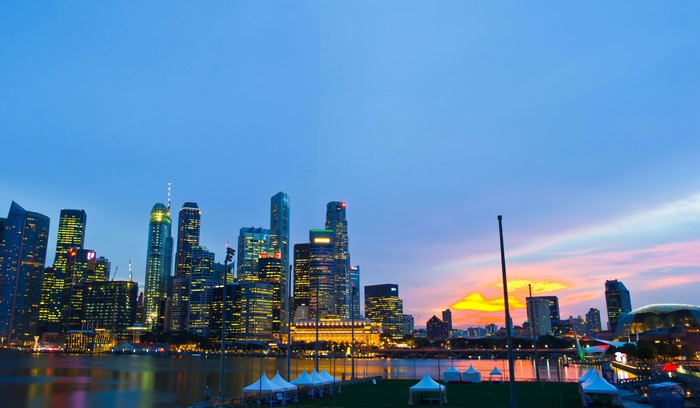 Singapore skyline at sunset with river and tents