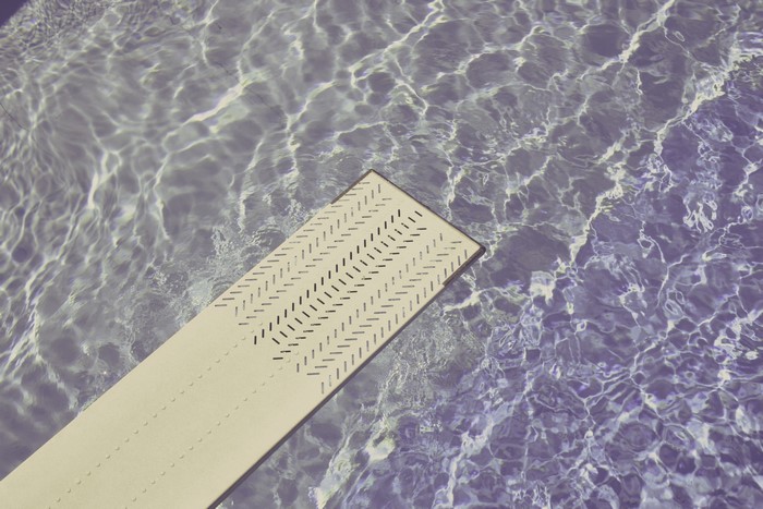 Diving board over rippling water