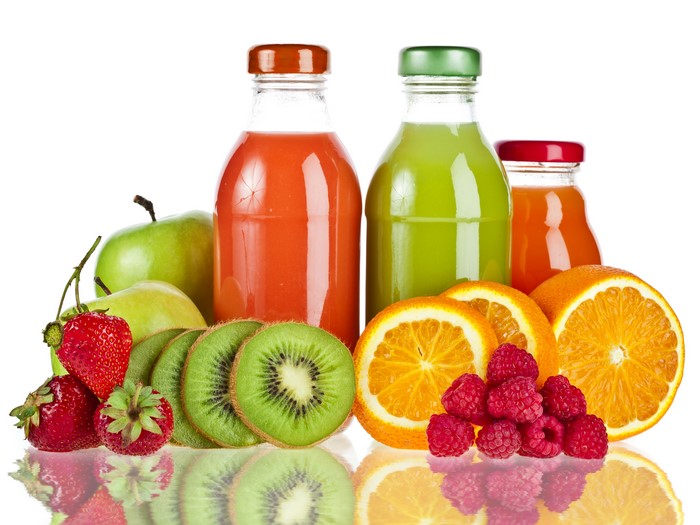 Bottles of juice with fresh fruits