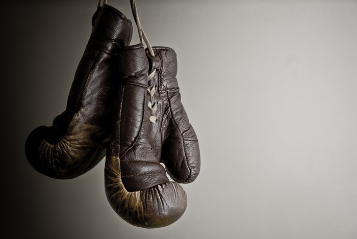 Pair of old brown boxing gloves hanging