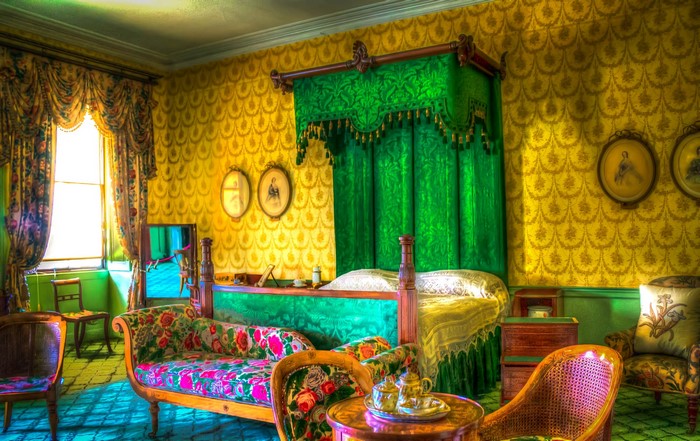 Ornate Bedroom with Canopy Bed and Floral Sofa