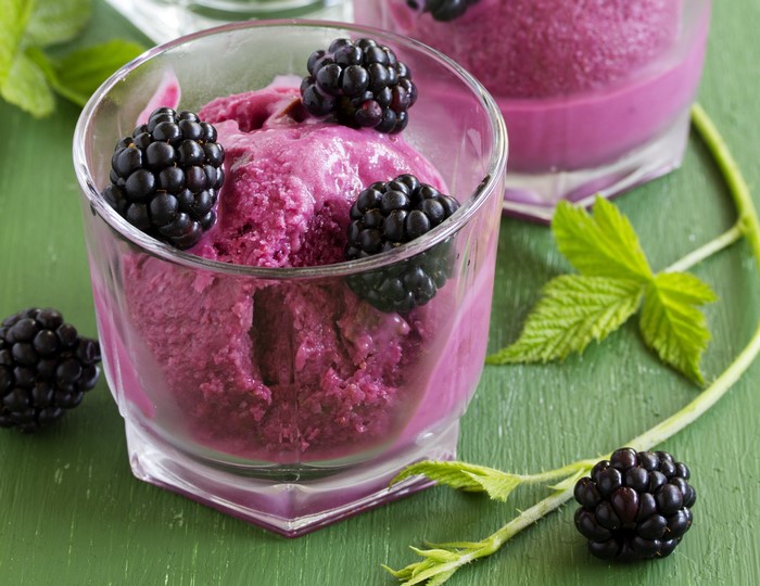Blackberry ice cream in a glass with fresh blackberries