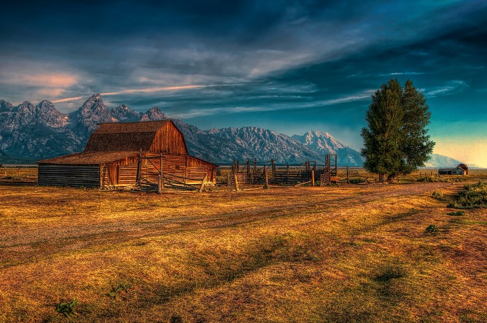 Barn and Mountains in a Field