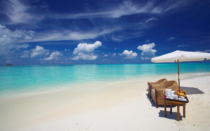 Tropical beach with chairs and umbrella