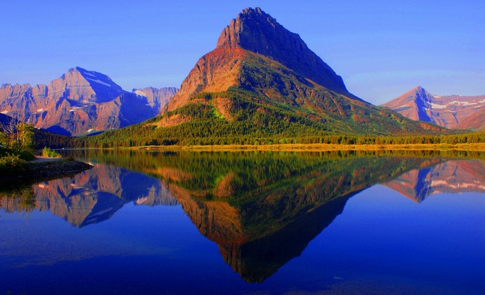 Mountains reflected in a lake in Glacier National Park, Montana, USA