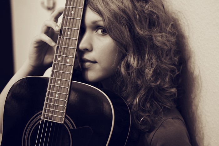 Woman holding an acoustic guitar