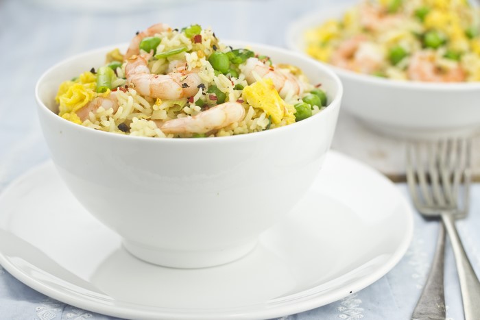 Shrimp fried rice with peas and egg in a bowl