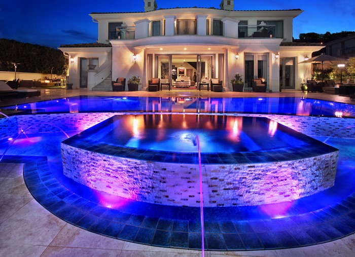 Luxury Villa with Illuminated Pool at Night