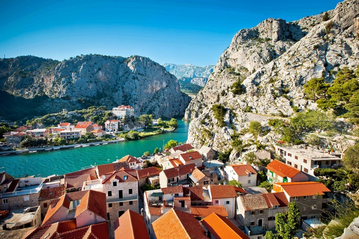 Town by a river between mountains in Croatia