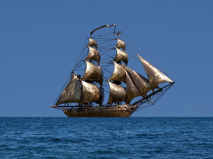 Golden sailing ship on the sea
