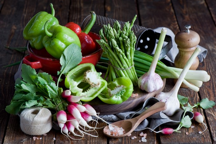 Assortment of fresh vegetables on a wooden table