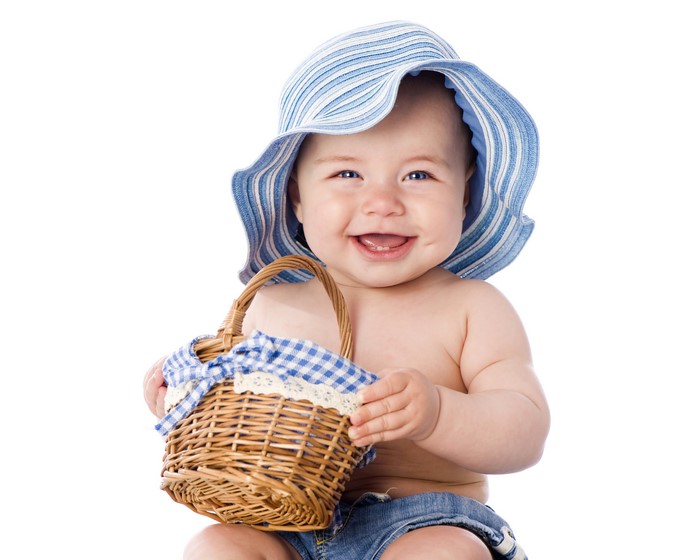 Baby in blue striped hat holding wicker basket