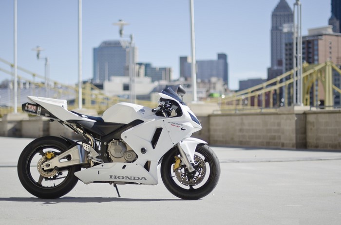 White Honda CBR600RR motorcycle in front of city skyline