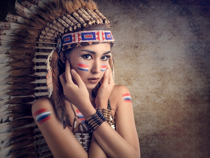 Woman in Native American Headdress with Face Paint