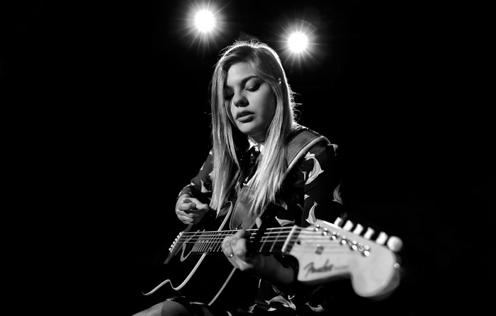 Louane Emera playing guitar