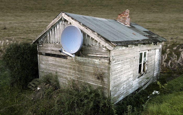 Old wooden house with satellite dish