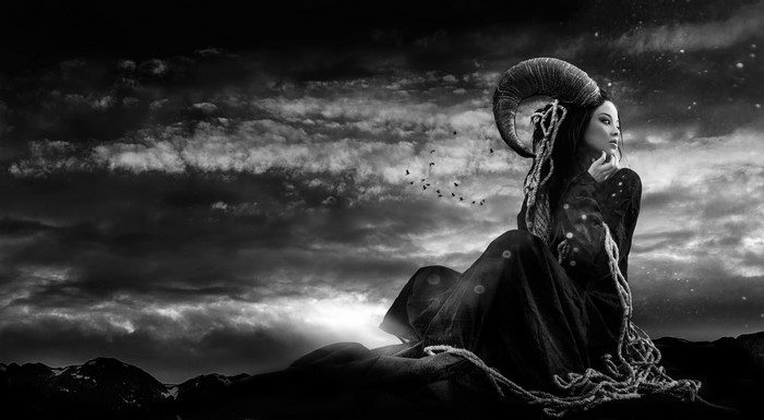 Woman with Ram Horns and Birds in Dramatic Sky