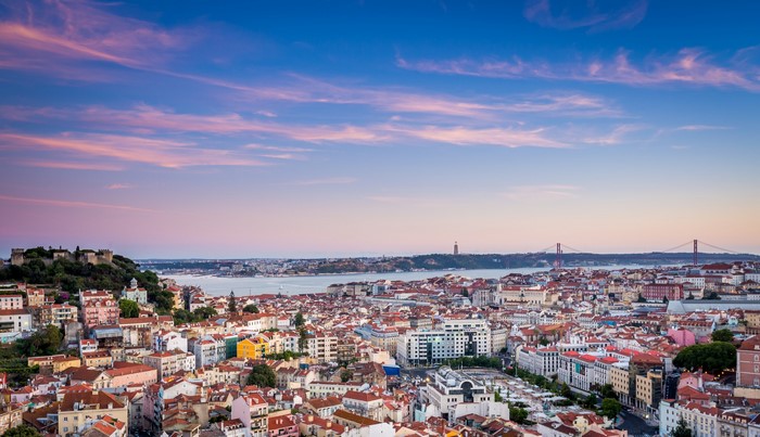 Lisbon cityscape with Tagus River and bridges at sunset