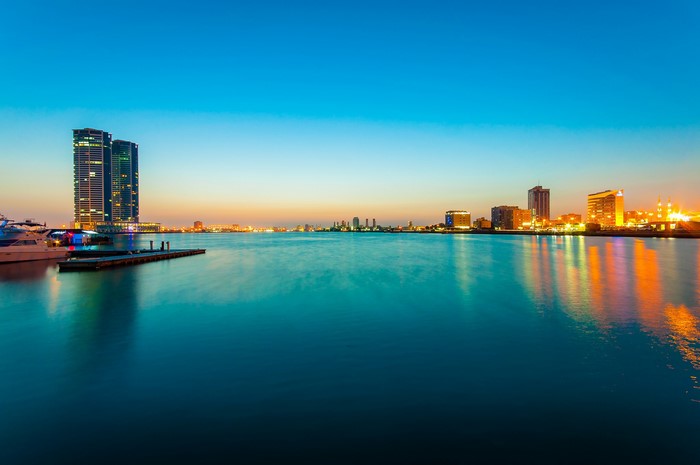 City skyline with skyscrapers and water at dusk
