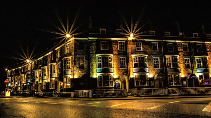 Terraced houses illuminated at night in Weymouth, England