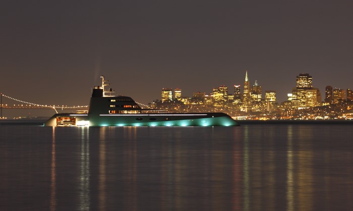 Luxury yacht at night with San Francisco skyline