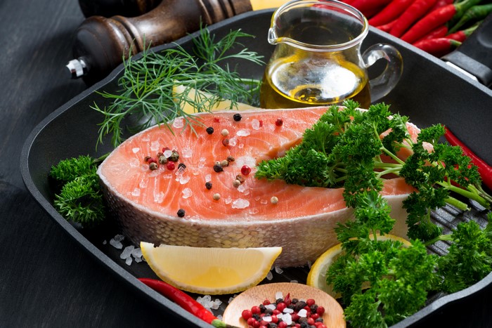 Salmon steak with dill, lemon, and chili peppers