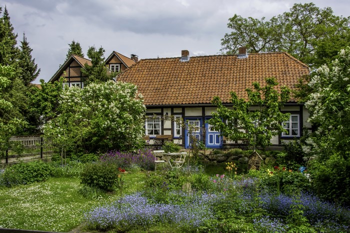 Half-timbered houses with blooming lilac and garden in Hitzacker, Germany