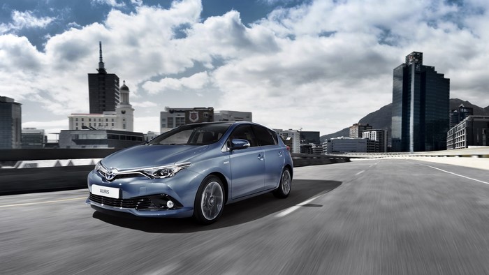 Metallic blue 2015 Toyota Auris driving in city