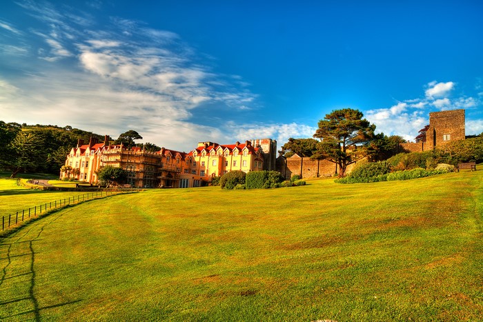 Castle and manor house on a grassy hill in Exmoor, England