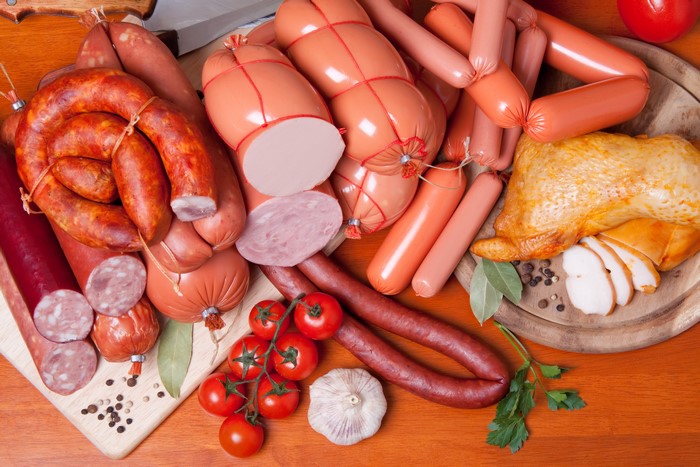Assortment of Sausages, Roast Chicken, and Tomatoes