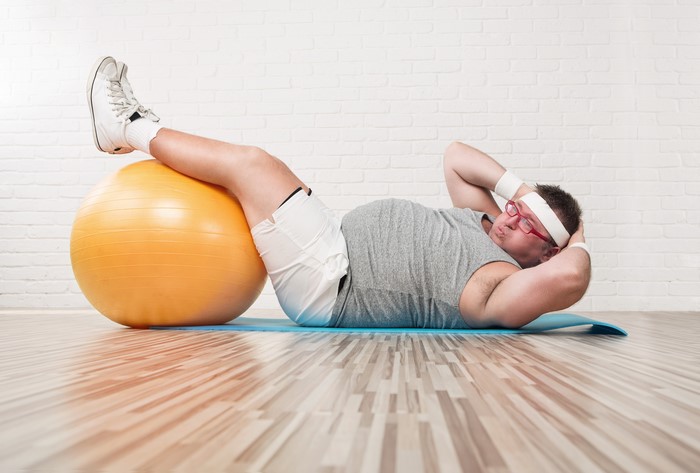 Man doing crunches with fitness ball
