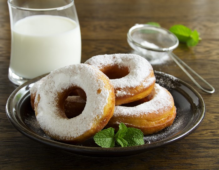 Donuts with powdered sugar and milk