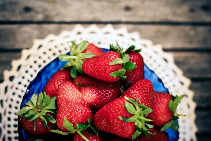 Close-up of fresh strawberries in a blue bowl