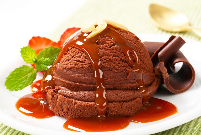 Chocolate ice cream with caramel and strawberries