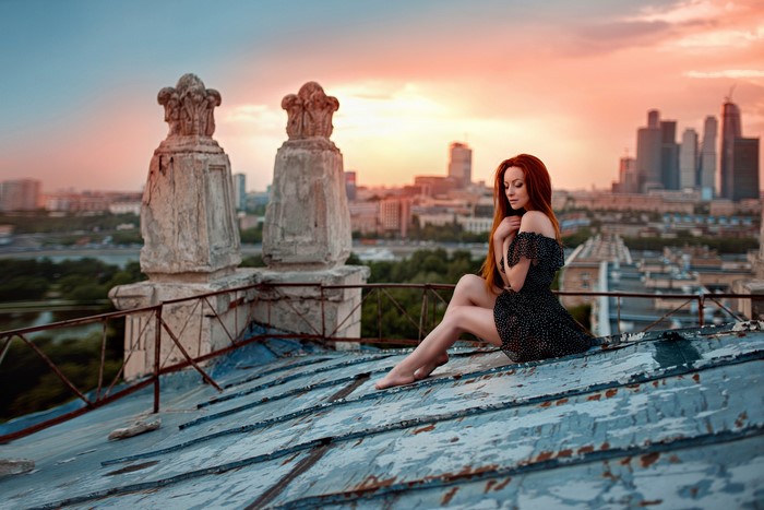 Redhead girl on a rooftop at sunset
