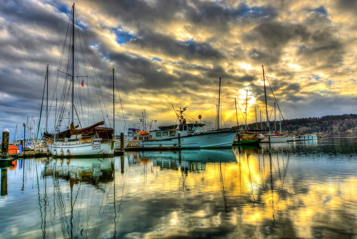 Boats docked at Poulsbo Marina, Washington during sunset